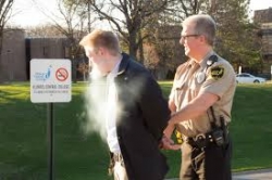 Parking officer issuing ticket to tobacco-free policy violator